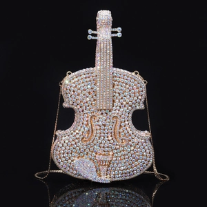 Detailed macro view of colorful AB rhinestones and gold metal frame on a violin evening bag