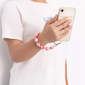 Cute pink cat paw bead phone wrist strap detail, perfect for aesthetic phone decoration.
