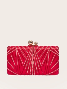Detail of red evening clutch featuring golden beads and a geometric V-pattern with clasp