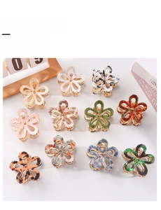 Flat lay of floral acetate hair claw clips in various colors and patterns with metal spring