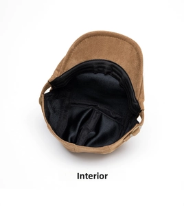 Detail of the brown faux suede cap showing black fabric lining and adjustable metal buckle