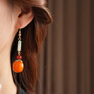 Elegant Persimmon-style dangle earrings with orange beads and green jade details