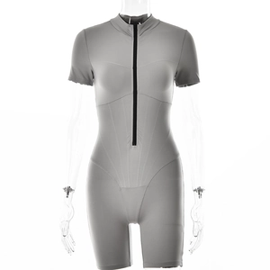 Detail of grey short sleeve ribbed bodysuit with functional zipper on a white background