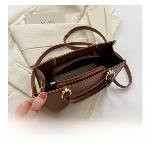 Interior view of brown lychee texture tote bag showing compartments and gold hardware