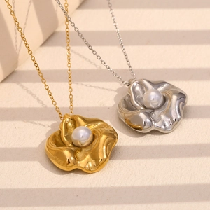 Gold and silver flower pendant necklaces with white pearl centers on an O-chain link