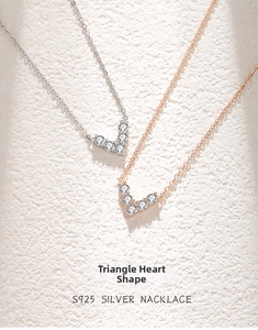 Macro detail of S925 sterling silver V-shaped heart pendants with zircon stones