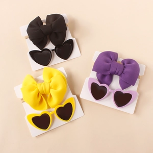 Kids hair accessory set with large fabric bow headband and heart-shaped sunglasses