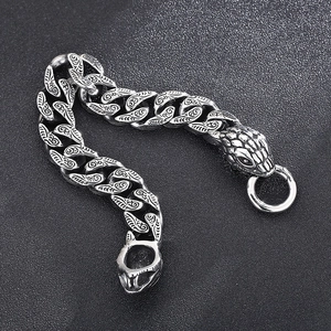 Macro detail of vintage snake head clasp on engraved curb chain punk bracelet