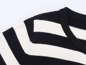 Close-up of black and white striped knit fabric with ribbed neckline detail