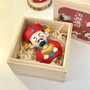 Macro detail of hand-carved wooden God of Wealth figurine in a wooden gift box