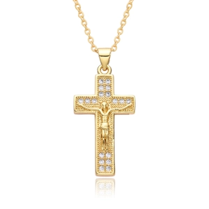 Macro detail of a gold crucifix pendant necklace with sparkling inlaid rhinestones