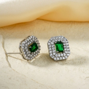 Elegant emerald cut green zircon stud earrings with sparkling silver halo setting