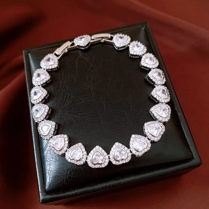 Detailed view of silver heart bracelet with cubic zirconia paving on black jewelry box