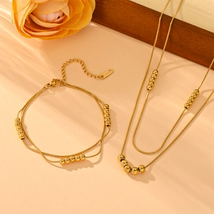 Elegant gold-plated titanium steel jewelry set featuring double-layer snake chains with beads