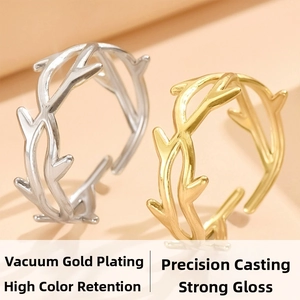 Close-up of gold and silver twig rings with high-gloss finish and adjustable open design