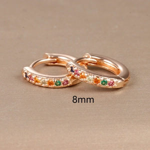 Detail view of 8mm rose gold huggie hoop earring with rainbow cubic zirconia stones