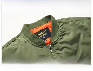 Detail of sage green bomber jacket showing stand collar with inner orange lining
