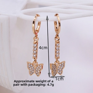 Detail shot of gold-plated butterfly drop earrings with rhinestones and size indicators
