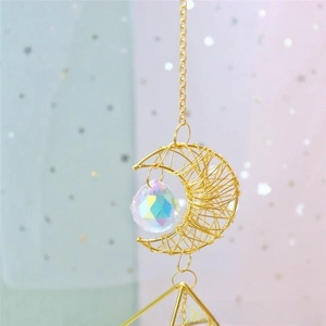 Macro detail of golden moon frame with faceted iridescent crystal ball suncatcher