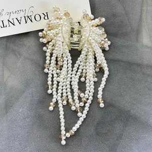 Elegant hair claw clip with pearl and champagne crystal long tassels on grey mesh fabric