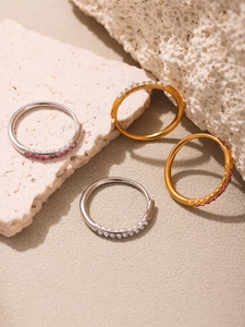 Detail view of gold and silver plated piercing rings with pink and white zircon stones