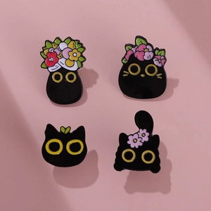 Set of four cute black cat enamel pins featuring colorful flowers and yellow eyes