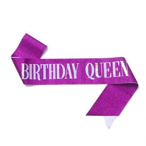 Close-up of glittery purple Birthday Queen sash with silver holographic lettering