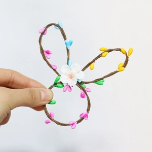 Handmade Easter bunny napkin ring with colorful beads and white flower for garden parties