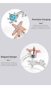 Detailed macro of a spinning ring with blue sea turtle and zircon star charms