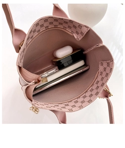 Top-down macro view showing spacious interior of pink plaid handbag with various essentials