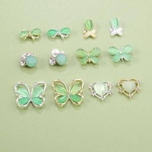 Detailed set of 12 mint green cat eye butterfly and heart nail art charms with crystals