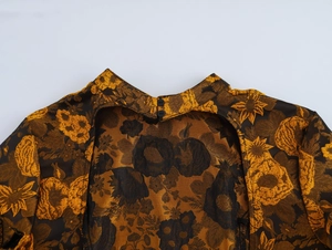 Detail of vintage jacquard dress showing stand collar with buttons and open back design