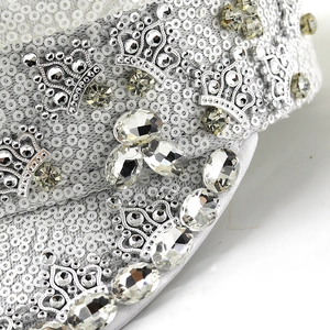 Macro detail of silver sequins and crown ornaments on the festival party captain hat