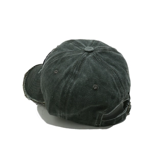 Close-up of distressed brim details and adjustable strap on a vintage washed baseball cap