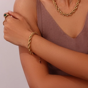 Close-up of 18K gold plated rope chain necklace and bracelet set worn by a model