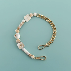 Detail of bohemian acrylic phone chain with marble beads and gold lobster clasps