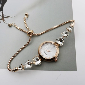 Rose gold quartz bracelet watch with round dial and crystal drop chain design