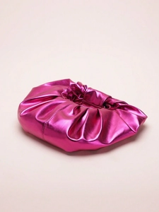 Detailed close-up of metallic magenta pleated dumpling bag with shiny faux leather texture