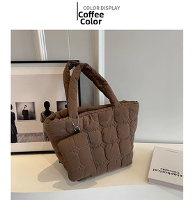Quilted tote bag detail in coffee brown with matching zipper pouch and wide straps