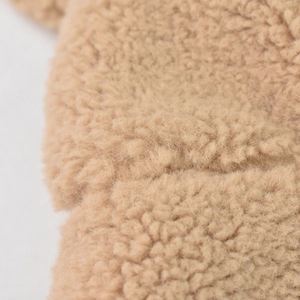 Macro shot of thick camel teddy wool fabric texture for winter bucket hat warmth