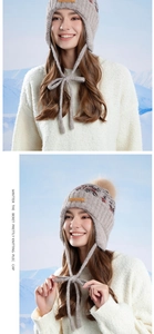 Detailed view of women's knitted earflap hat with Nordic patterns and faux fur pom-poms