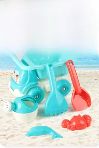Kids beach toy set with blue dump truck, shovel, rake and sand molds on sunny seaside