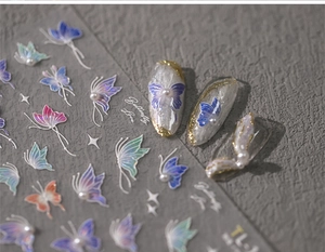 Detailed macro view of 5D butterfly nail stickers with purple gradients and pearl accents