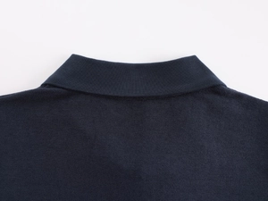 Close-up detail of the navy blue polo collar showing high-quality stitching and fabric texture
