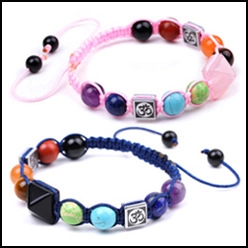Detail of pink and blue beaded bracelets with stone pyramids and adjustable cord