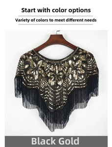 Détail d'un châle en maille noire avec paillettes dorées et longues franges élégantes
