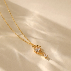 Macro detail of 18K gold plated fan-shaped necklace with zircon stones and artistic shadows