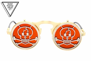 Detailed macro view of gold metal frames with orange lenses and skull crossbone design