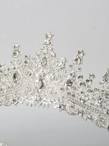 Close-up of a shimmering silver tiara with rhinestones and elegant crystal detailing