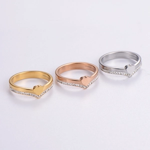 Detail of heart-shaped v-rings with cubic zirconia in gold, rose gold and silver